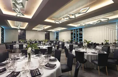 a banquet hall with white tables and chairs at Hotel Indigo Los Angeles Downtown by IHG in Los Angeles