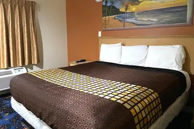 a hotel room with a large bed in a room at Robinhood Motel Anaheim West in Anaheim