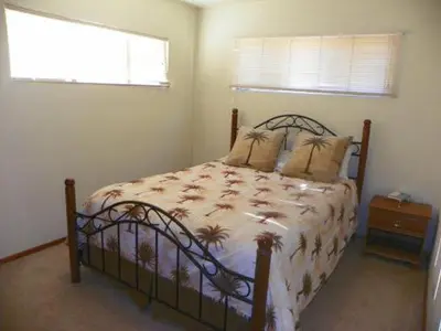 a bedroom with a bed and a window and a bed sidx sidx sidx at Kern Riverfront Lodge in Kernville