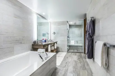 a white bathroom with a tub and a sink at InterContinental - Los Angeles Downtown by IHG in Los Angeles