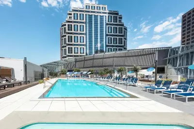 a swimming pool with lounge chairs and buildings at InterContinental - Los Angeles Downtown by IHG in Los Angeles