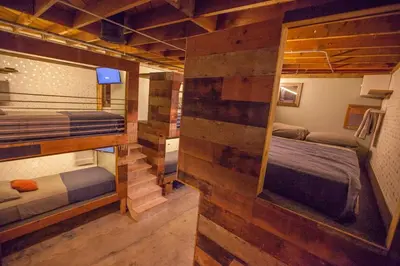 a room with two bunk beds and a mirror at PodShare East Hollywood in Los Angeles