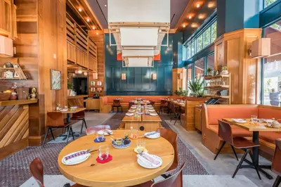 a dining room with wooden tables and chairs at Freehand Los Angeles in Los Angeles