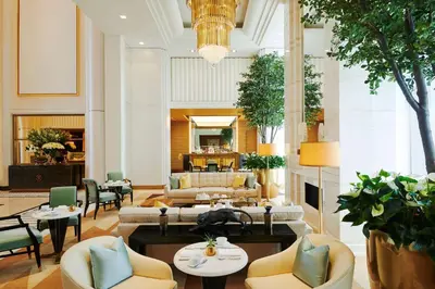 a hotel lobby with couches and tables and chairs at Waldorf Astoria Beverly Hills in Los Angeles