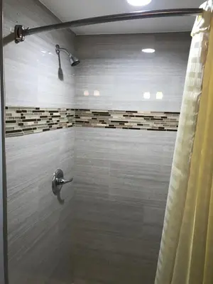 a bathroom with a shower with a shower curtain at Empire Inn in Los Angeles