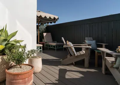 a patio with chairs and tables and an umbrella at Le Petit Pali Brentwood in Los Angeles