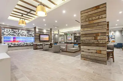 an office lobby with a wooden accent wall at SpringHill Suites by Marriott Huntington Beach Orange County in Huntington Beach