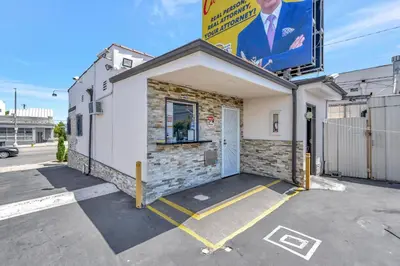 a building with a sign on the side of it at Mid City Inn in Los Angeles