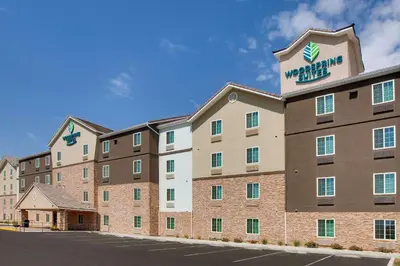 a hotel with a sign on the top of it at WoodSpring Suites Bakersfield East in Bakersfield