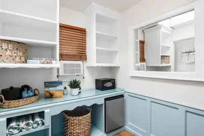 a kitchen with a blue counter and a window at Sea Blue Hotel in Los Angeles