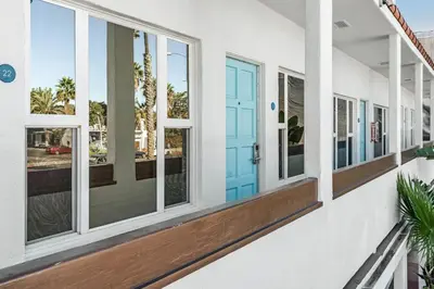 a row of windows on a house with a blue door at Sea Blue Hotel in Los Angeles