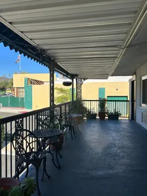 a patio with tables and chairs on a building at Welcome Inn in Los Angeles