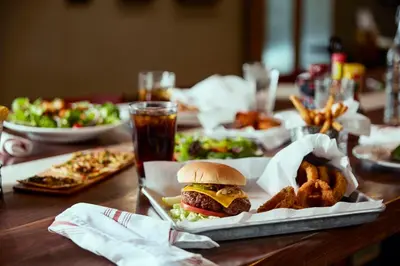 a table with a sandwich and some food on it at Holiday Inn Oxnard - Ventura by IHG in Oxnard