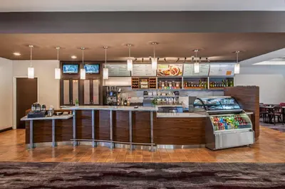 a bar in a restaurant with a counter at Holiday Inn Oxnard - Ventura by IHG in Oxnard