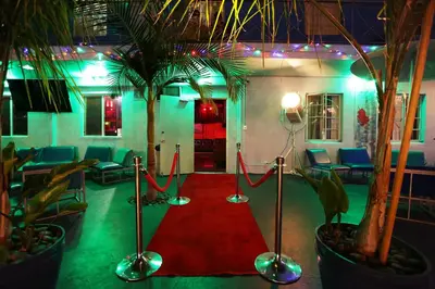a room with a red carpet and two palm trees at Banana Bungalow Hollywood Hotel & Hostel in Los Angeles