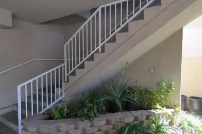 a staircase with plants and a stone wall at Florentina Motel - Los Angeles in Los Angeles