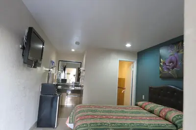 a hotel room with a bed and a kitchen at Florentina Motel - Los Angeles in Los Angeles