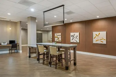 a dining room with a table and some chairs at Staybridge Suites Oxnard - River Ridge by IHG in Oxnard