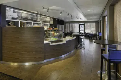 a bar in a restaurant with tables and chairs at Courtyard by Marriott Riverside UCR/Moreno Valley Area in Riverside