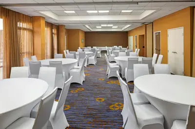 a conference room with white tables and white chairs at Courtyard by Marriott Riverside UCR/Moreno Valley Area in Riverside