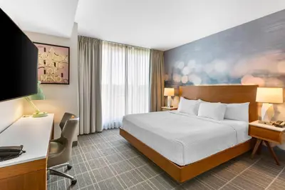 a hotel room with a bed and a desk at Cambria Hotel LAX in El Segundo