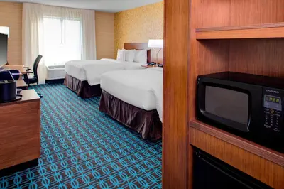 a hotel room with two beds and a television at Fairfield Inn & Suites by Marriott Bakersfield North/Airport in Bakersfield