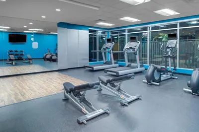 a gym with several treadms and cardio machines at Fairfield Inn & Suites by Marriott Bakersfield North/Airport in Bakersfield