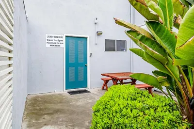 a door to a building with a table and a bench at Sugar Shack in Carpinteria