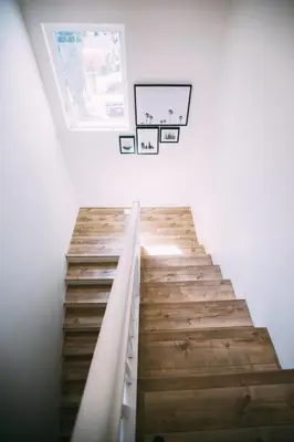 a staircase in a house with wooden floors and a window at Noon on Sunset Hill in Los Angeles