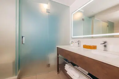 a bathroom with a sink and a shower at The Cove Hotel in Long Beach