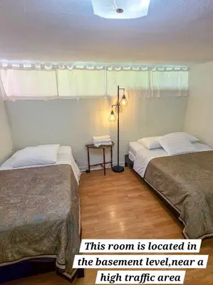 a room with two beds and a lamp and a room with a bed at Orange Drive Hostel in Los Angeles
