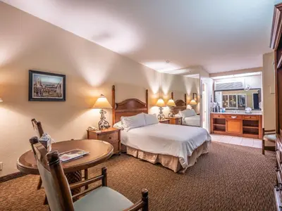 a hotel room with a bed and a table and a desk at Casa Ojai Inn in Ojai