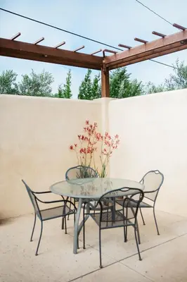 a table and two chairs and a table with flowers on it at Casa Ojai Inn in Ojai