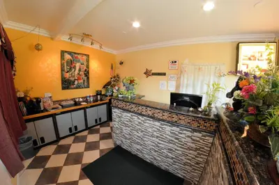 a kitchen with a bar with a checkered floor at The Palace Inn in Oxnard