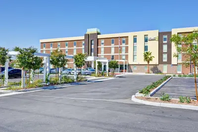 an empty parking lot in front of a building at Home2 Suites Azusa in Azusa