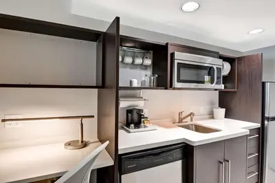 a kitchen with a sink and a microwave at Home2 Suites Azusa in Azusa