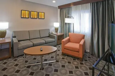 a living room with a couch and a chair at DoubleTree by Hilton Rosemead in Rosemead