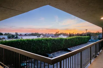 a view of a sunset from a balcony at Gateway Inn Gardena Los Angeles South in Gardena
