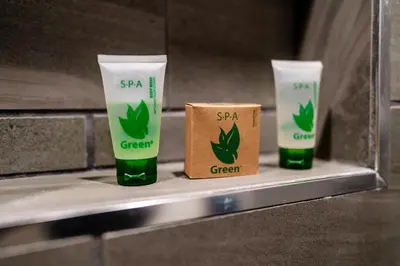 a shelf with three cups of green drink at Gateway Inn Gardena Los Angeles South in Gardena