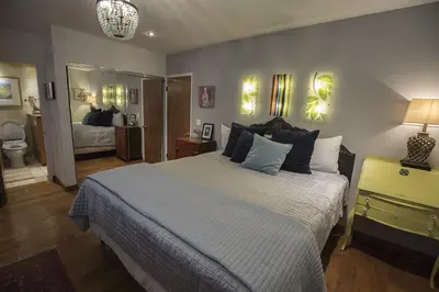 a bedroom with a large bed and a bathroom at Artistic Resort Like Home with Pool in Fullerton