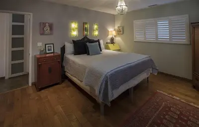 a bedroom with a large bed and a night stand at Artistic Resort Like Home with Pool in Fullerton