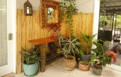 a room with potted plants and a wooden table at Artistic Resort Like Home with Pool in Fullerton