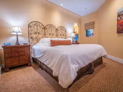 a bedroom with a large bed and a wooden dresser at Su Nido Inn in Ojai