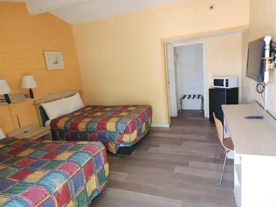 a hotel room with two beds and a kitchen at Town House Motel in Lancaster