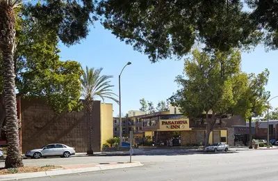 a street with cars parked in front of a store at GreenTree Pasadena in Pasadena