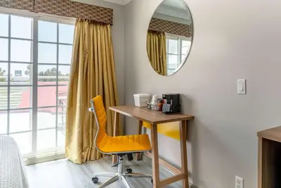a desk and chair in a room with a mirror at Days Inn by Wyndham Santa Monica in Los Angeles