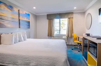 a hotel room with a large bed and a desk at Days Inn by Wyndham Santa Monica in Los Angeles