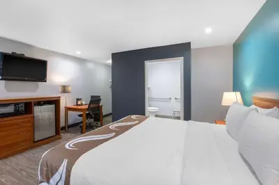a hotel room with a large bed and a flat screen tv at Quality Inn Near Hollywood Walk of Fame in Los Angeles