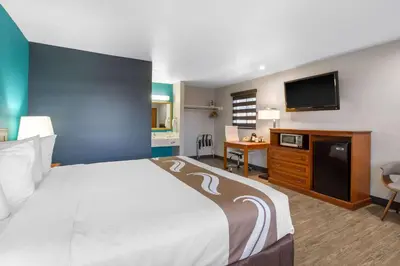 a hotel room with a bed and a flat screen tv at Quality Inn Near Hollywood Walk of Fame in Los Angeles