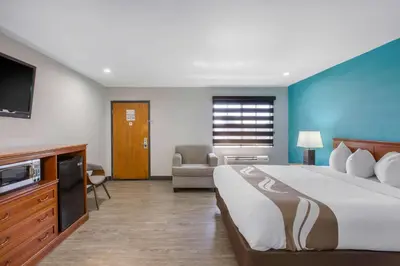 a hotel room with a large bed and a tv at Quality Inn Near Hollywood Walk of Fame in Los Angeles